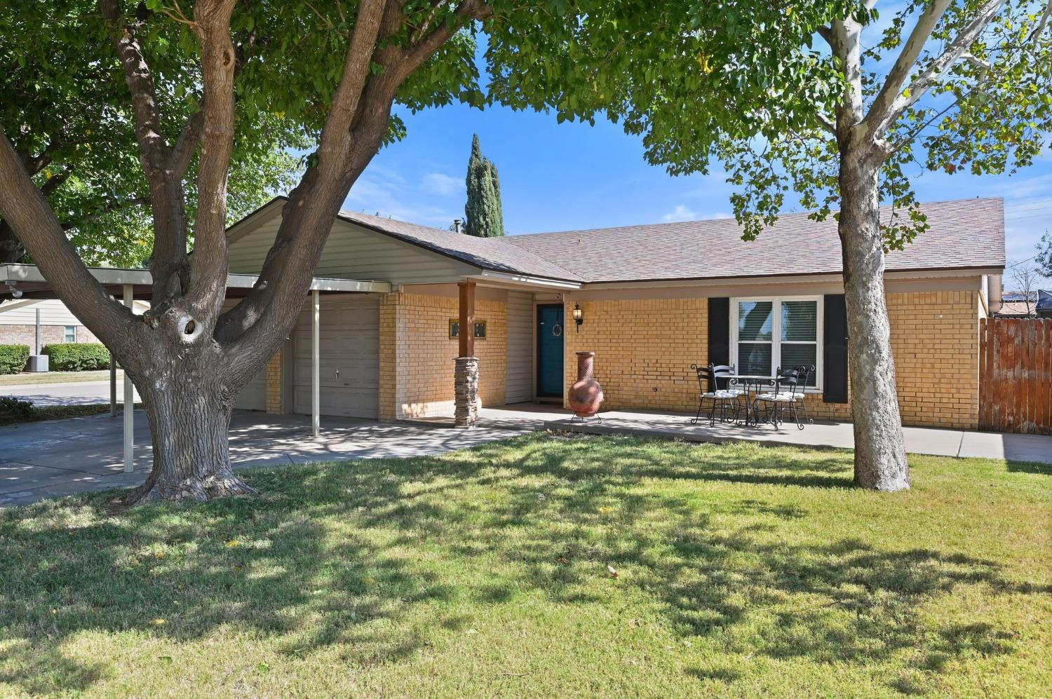 a front view of house with yard and green space