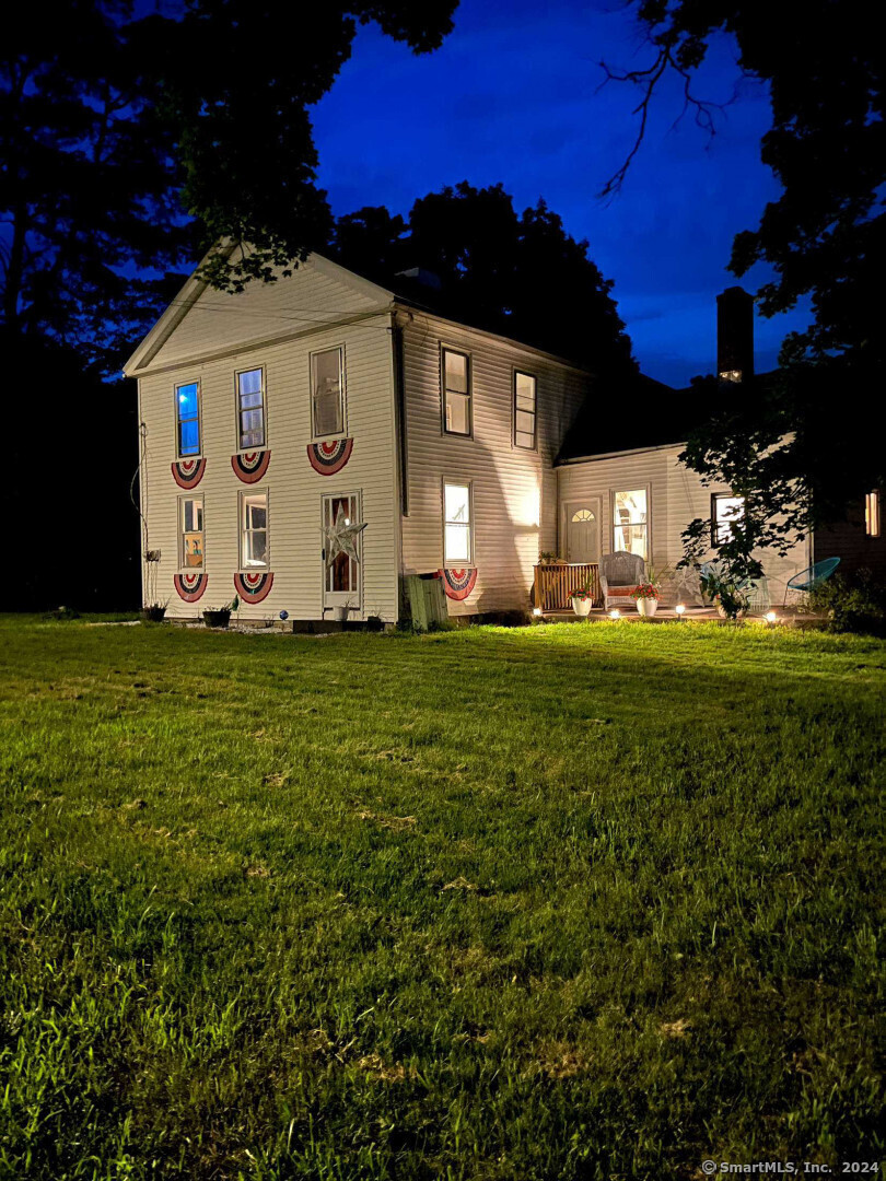 a front view of a house with a big yard