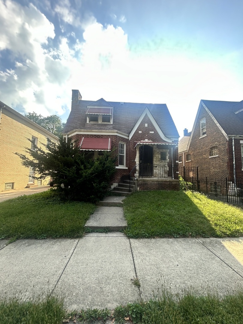 a front view of a house with a garden