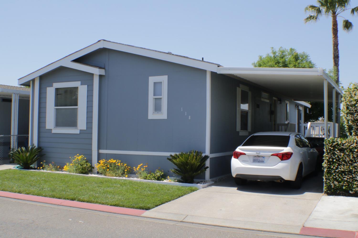 a front view of a house with a garden