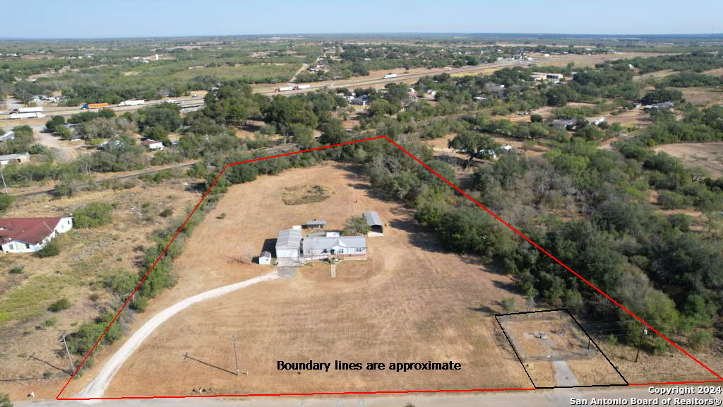 an aerial view of a house with a yard