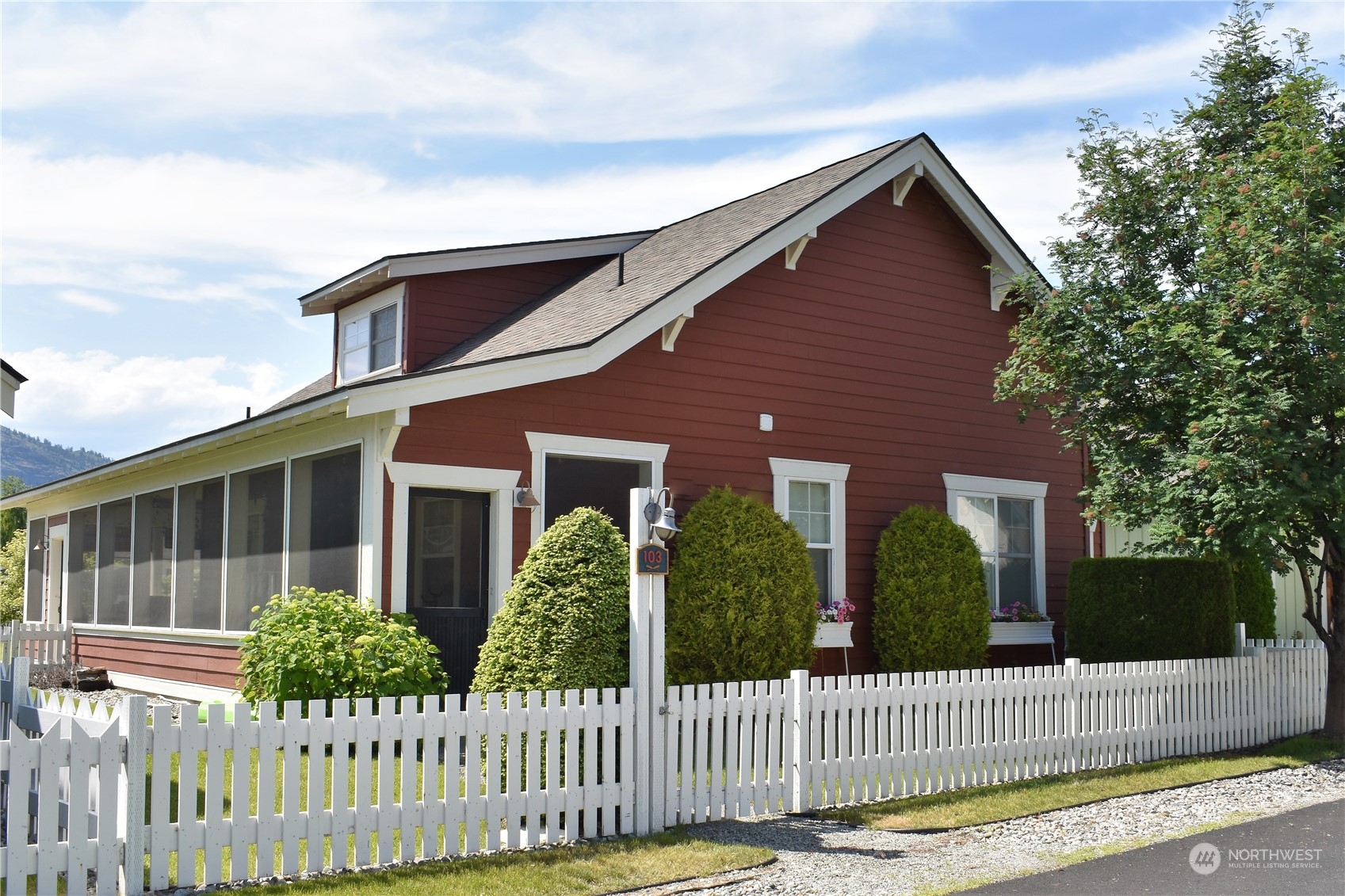 a front view of a house with tree