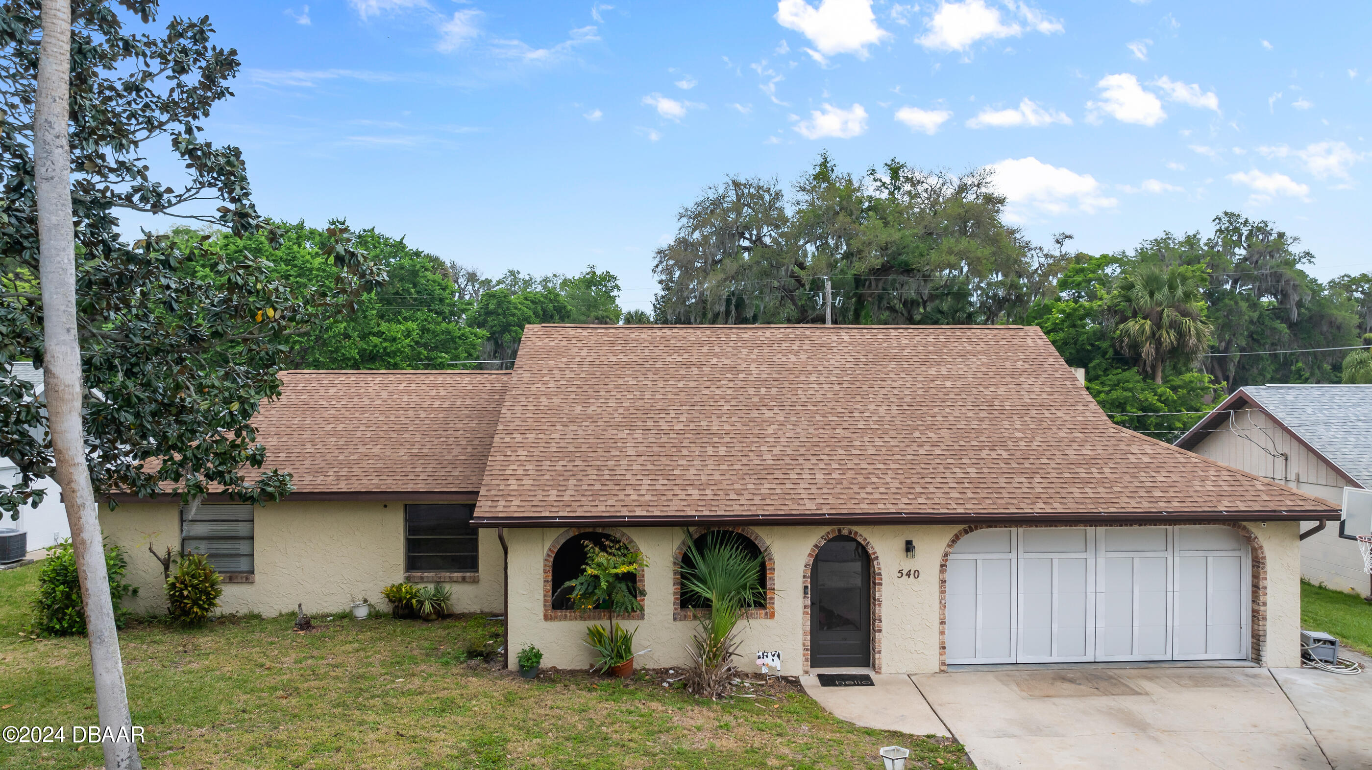 a front view of a house with garden