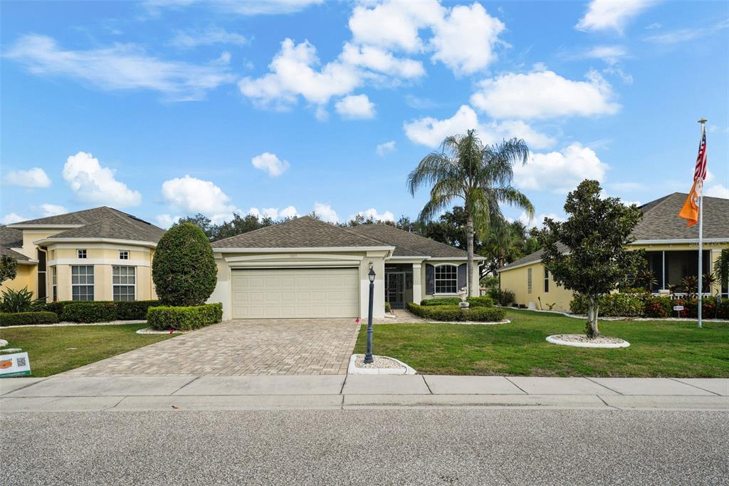 a front view of a house with a yard and garage