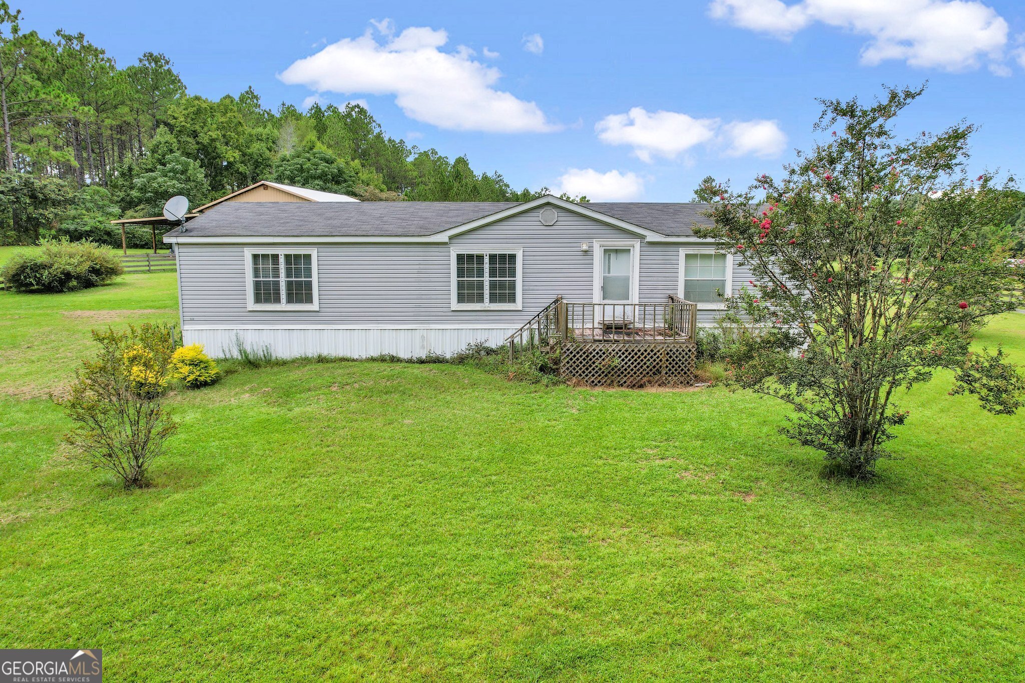 a front view of a house with yard and green space