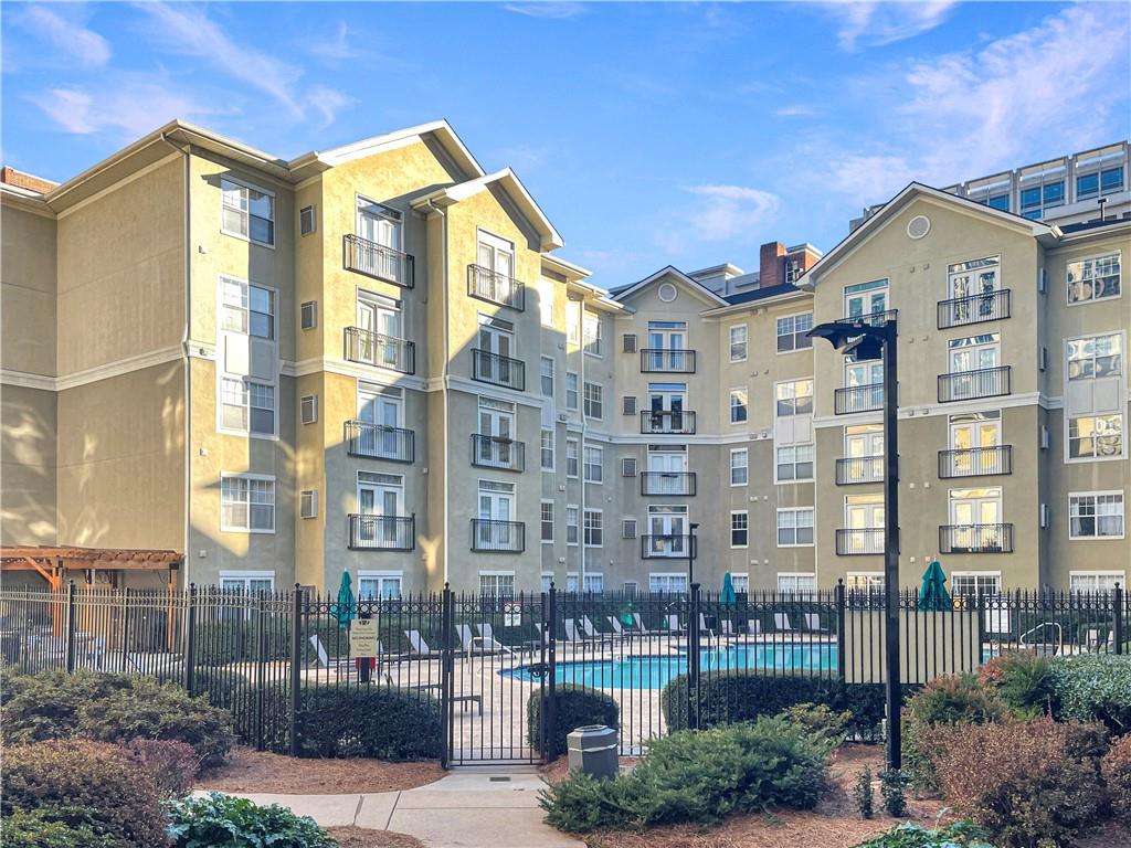 a front view of a residential apartment building with a yard