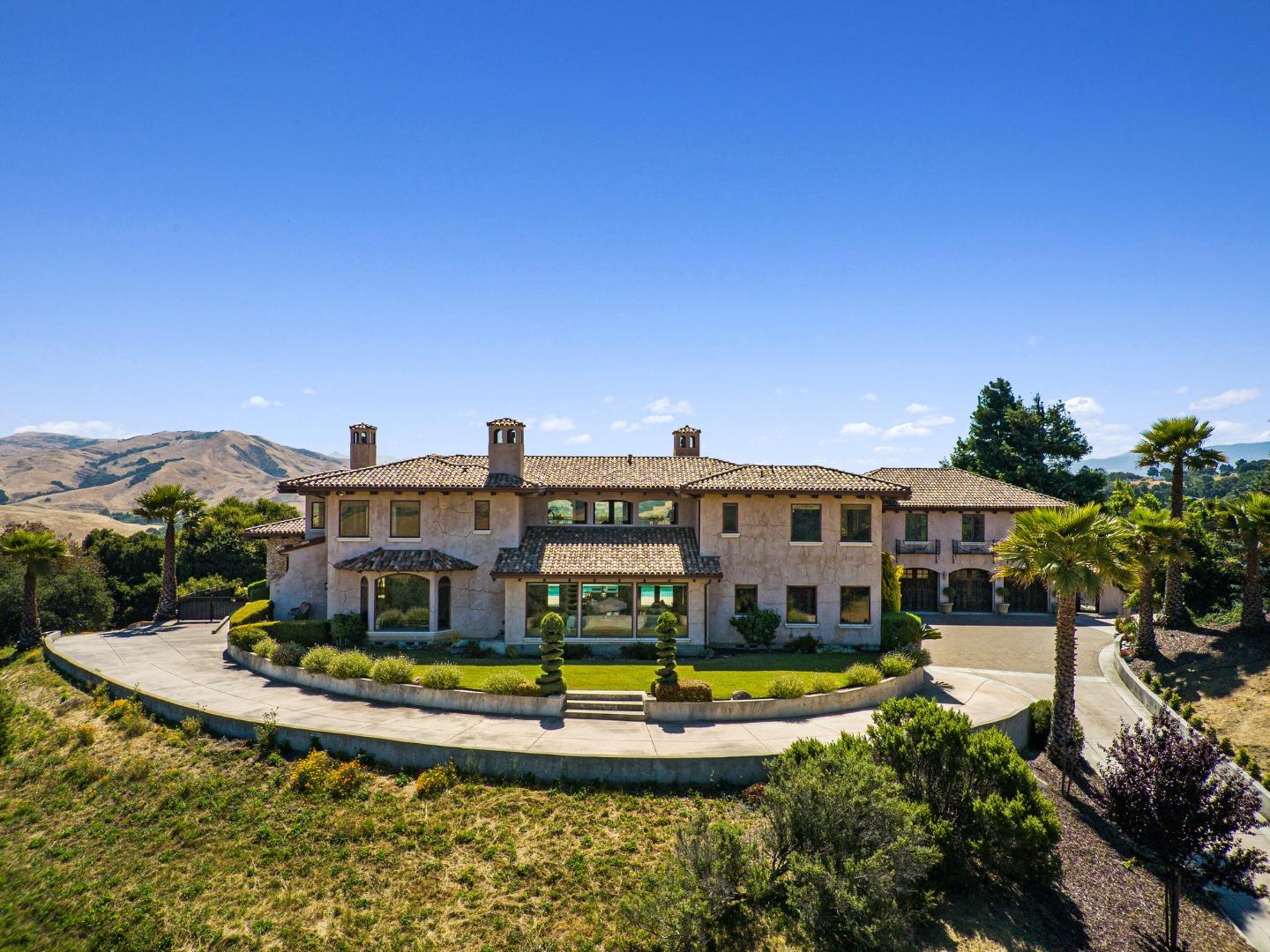 a view of a house with swimming pool and a yard