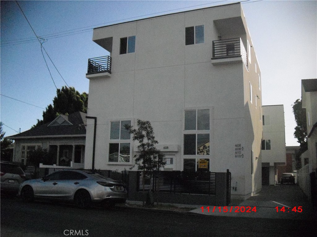 a couple of cars parked in front of a house