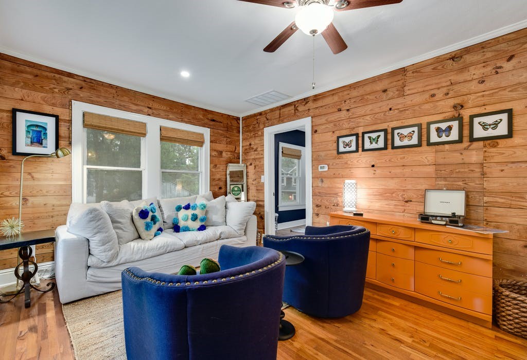 a living room with stainless steel appliances kitchen island granite countertop a sink and cabinets