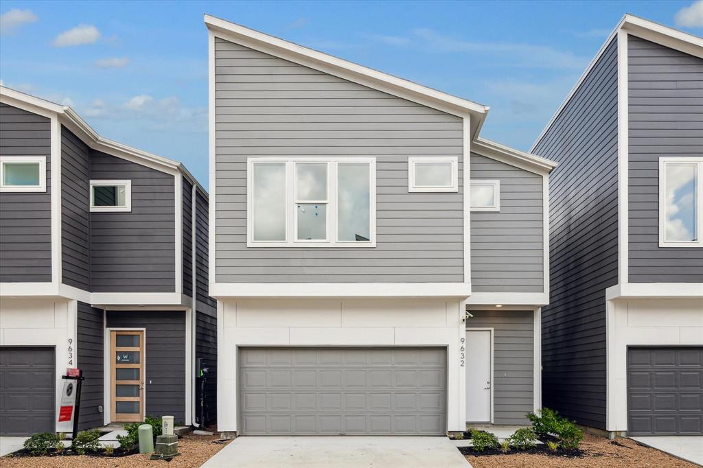 a front view of a house with garage