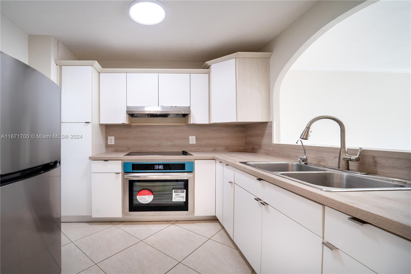 a kitchen with granite countertop a sink stove and cabinets