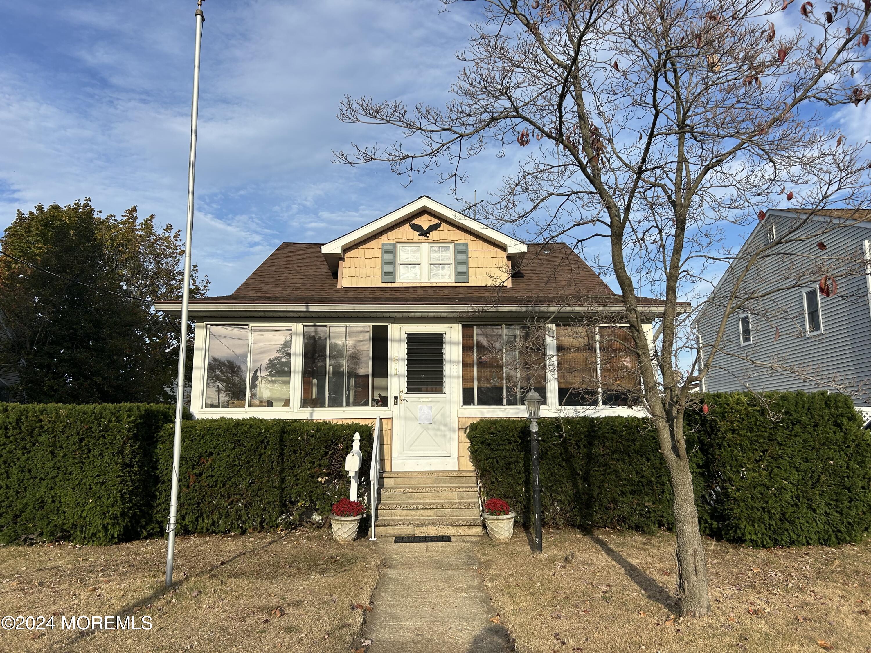 a front view of a house with a garden