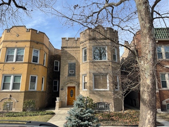 a view of a brick house with large windows