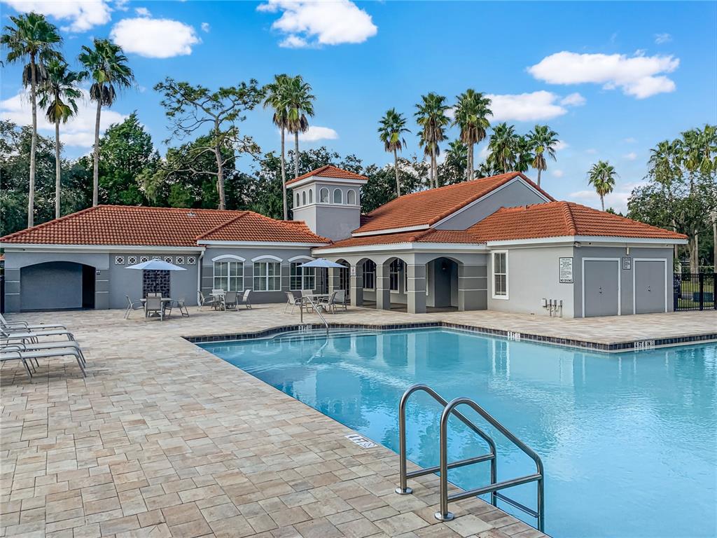 a front view of a house with swimming pool having outdoor seating