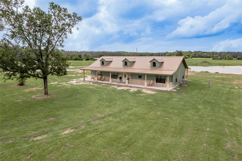 a view of a big yard with a house in the background