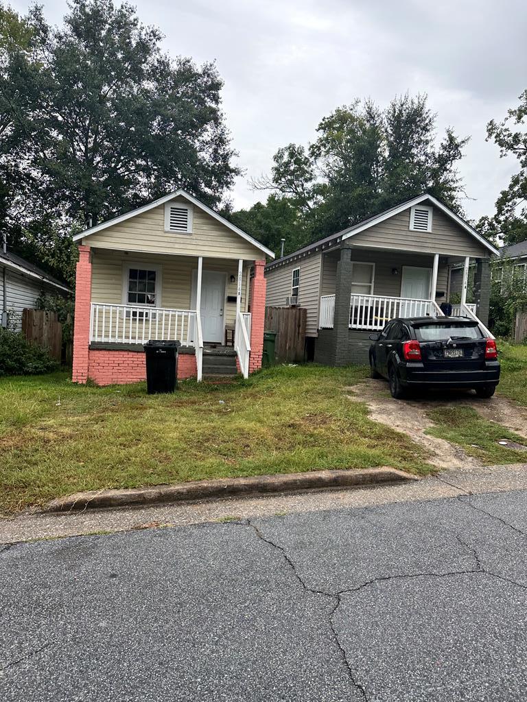 a front view of a house with a garden