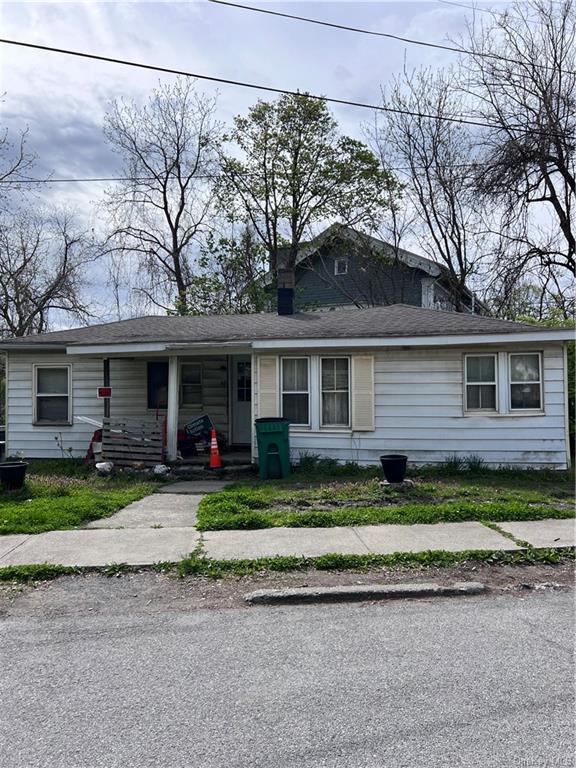 a front view of a house with a yard and porch