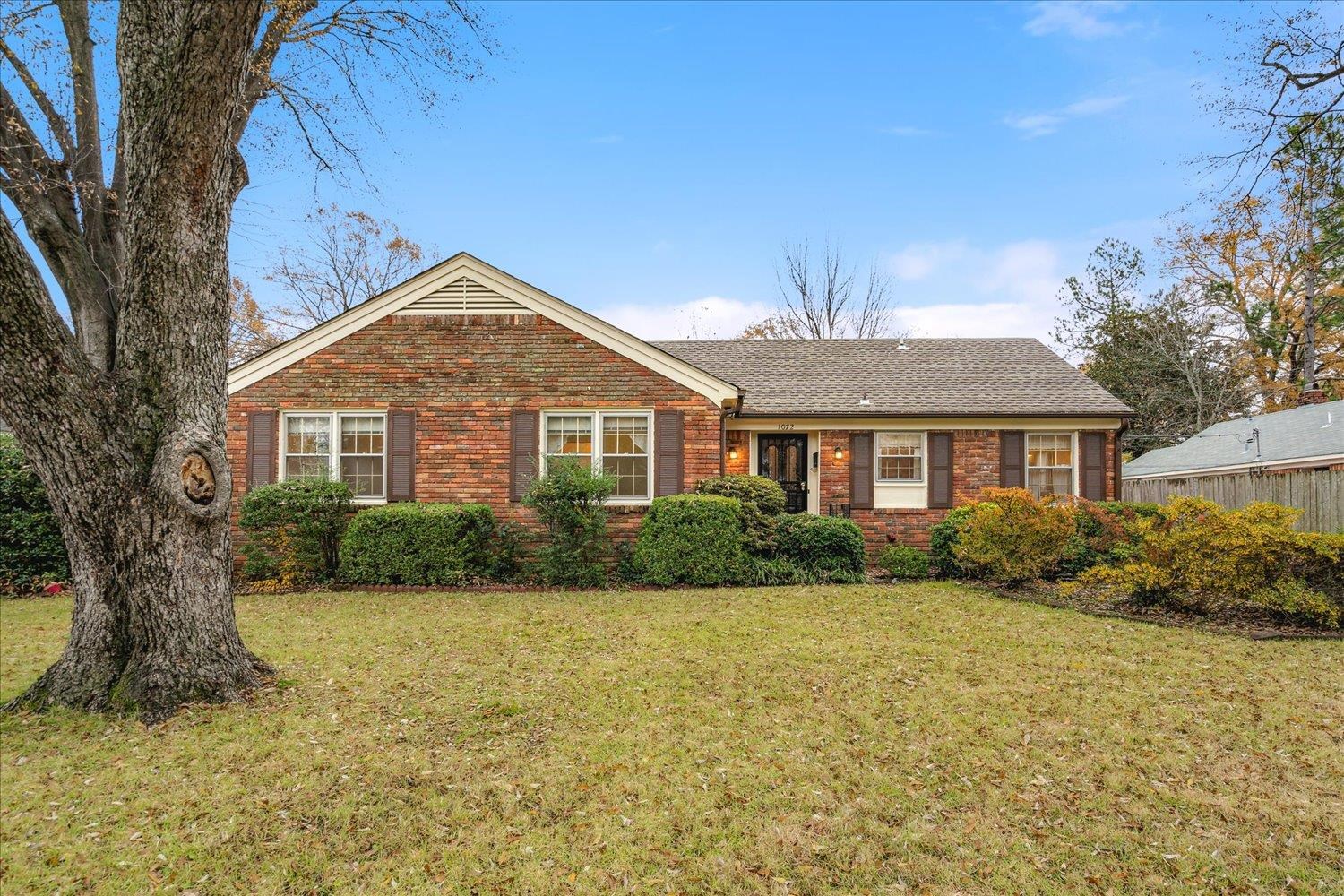 Single story home featuring a front lawn