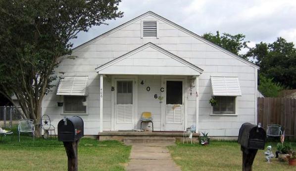 Bungalow-style house with a front yard