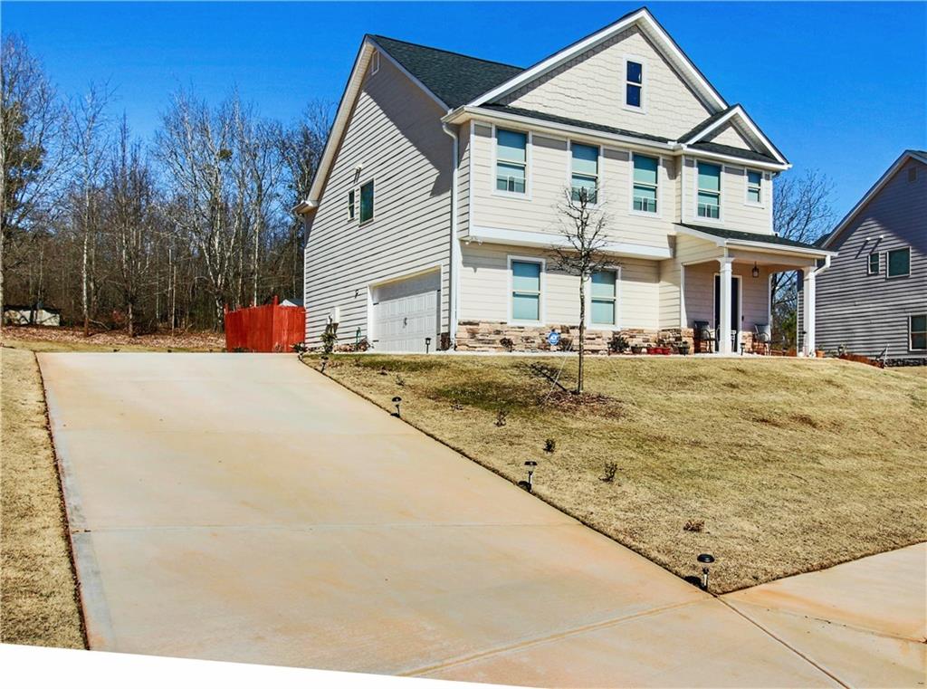 a front view of a house with a yard