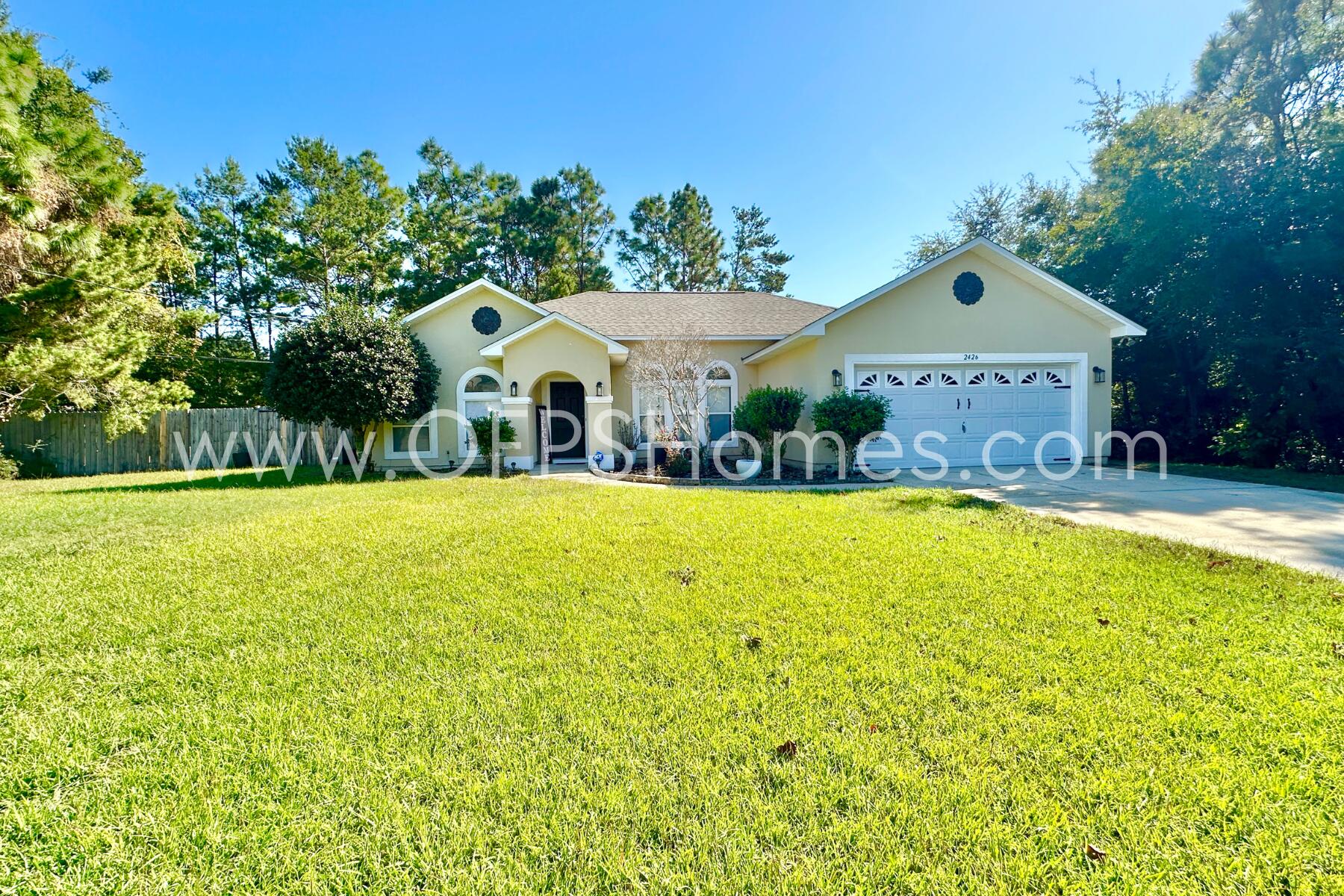 a front view of house with yard and green space