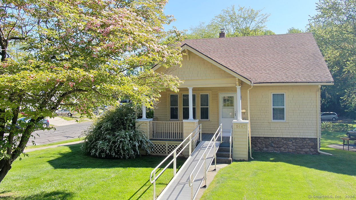 a view of house with backyard and garden