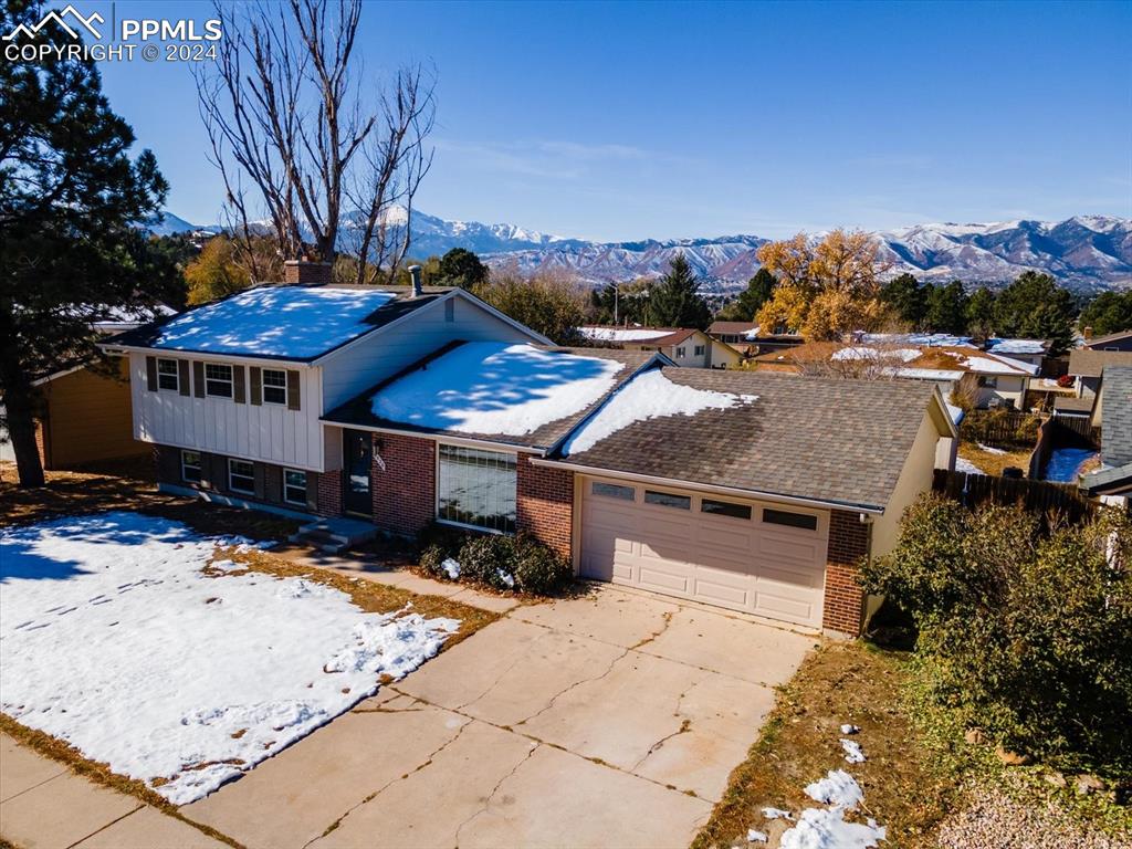 Front view of the home with mountain view and a garage