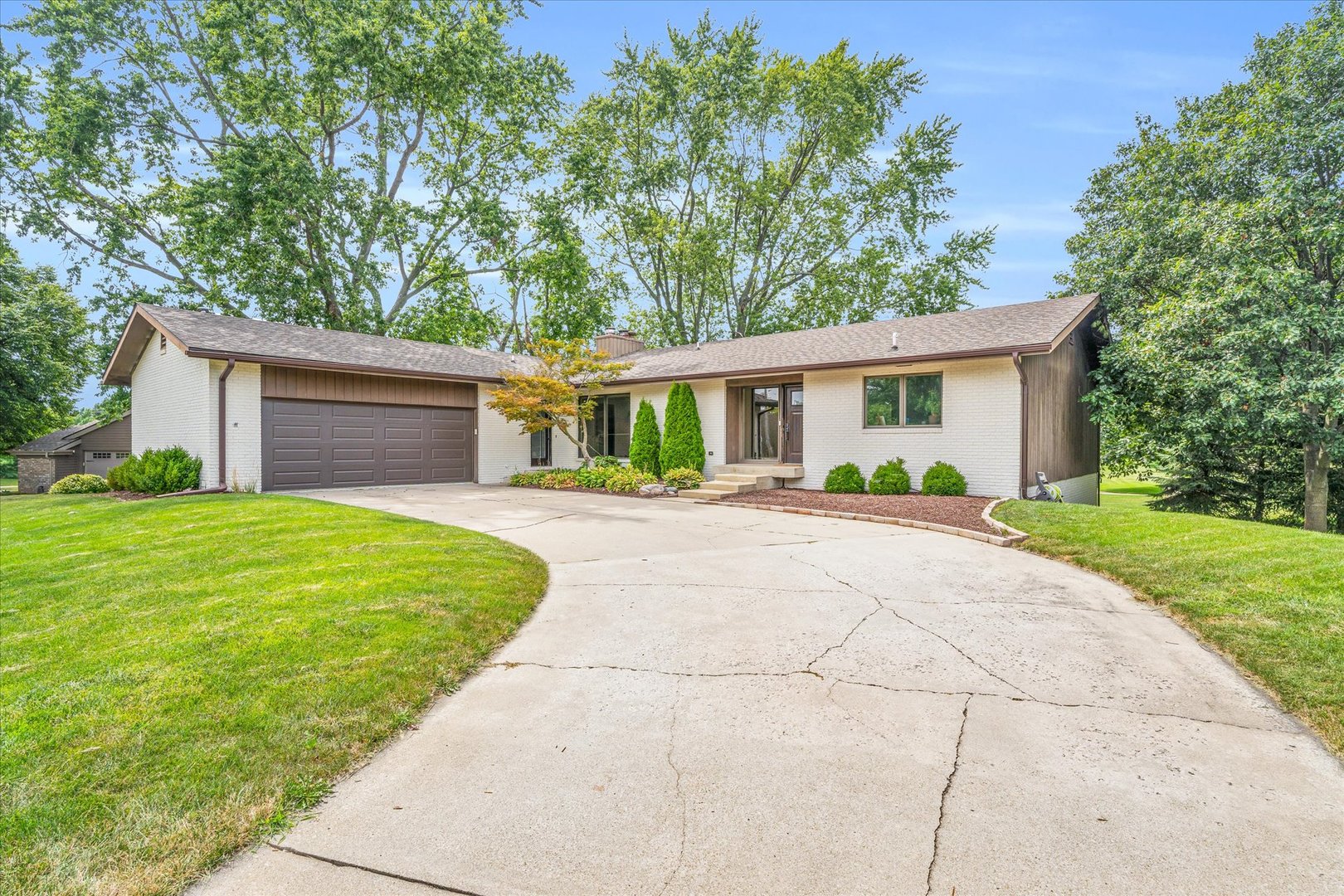 a front view of house with yard and green space