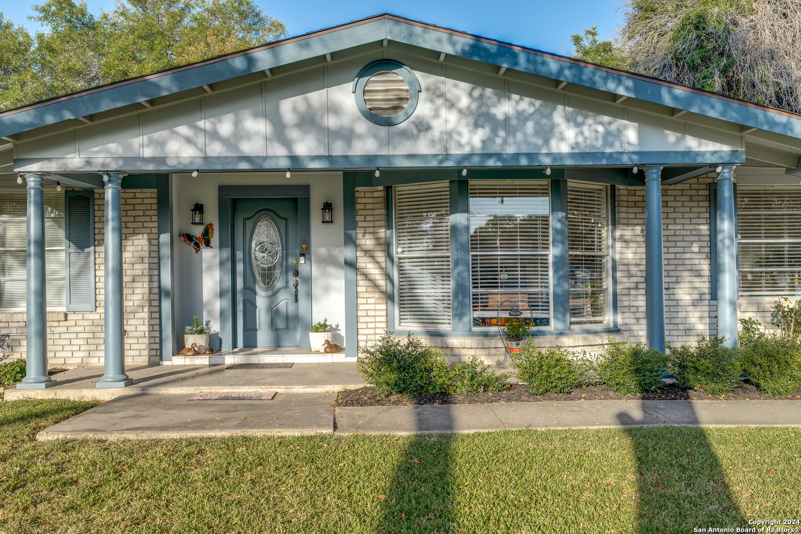 a front view of a house with garden