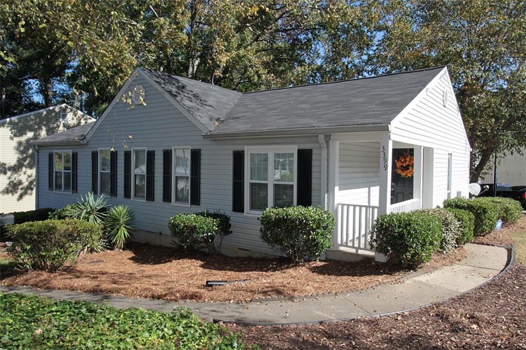 a view of a house with a small yard and plants