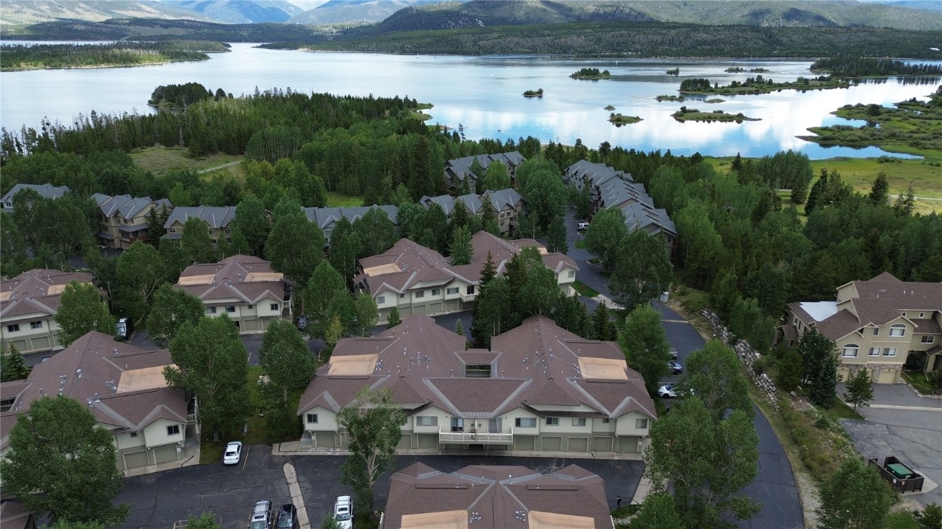 an aerial view of a house with garden space and lake view