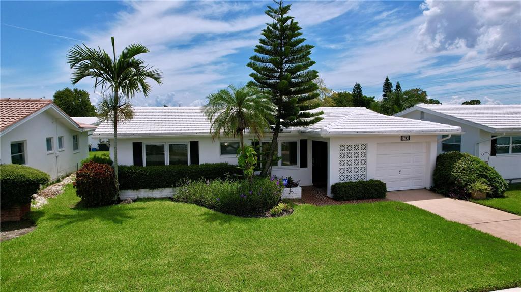 a front view of a house with a yard and garage