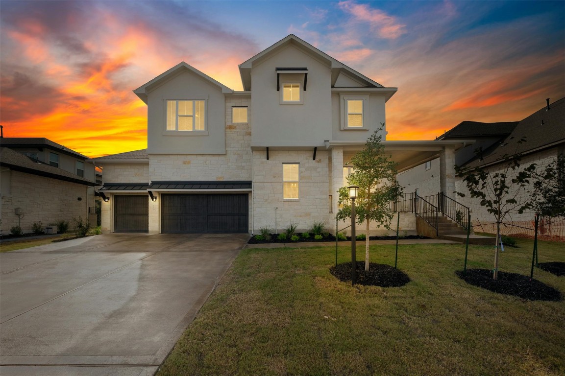 a front view of a house with a yard and garage