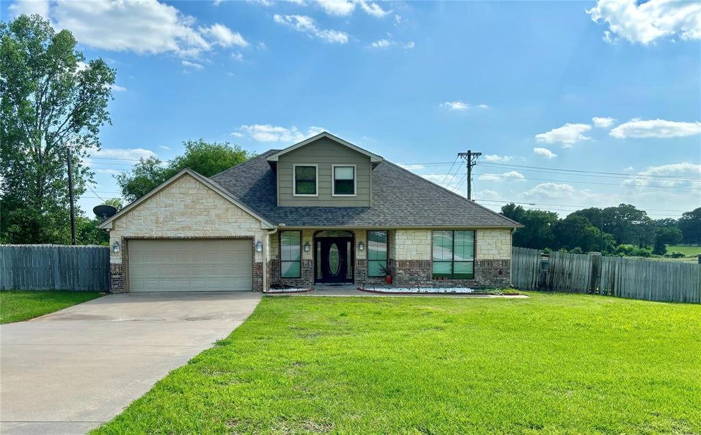 a front view of house with a garden