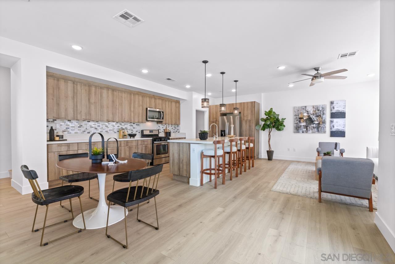 a living room with furniture and kitchen view