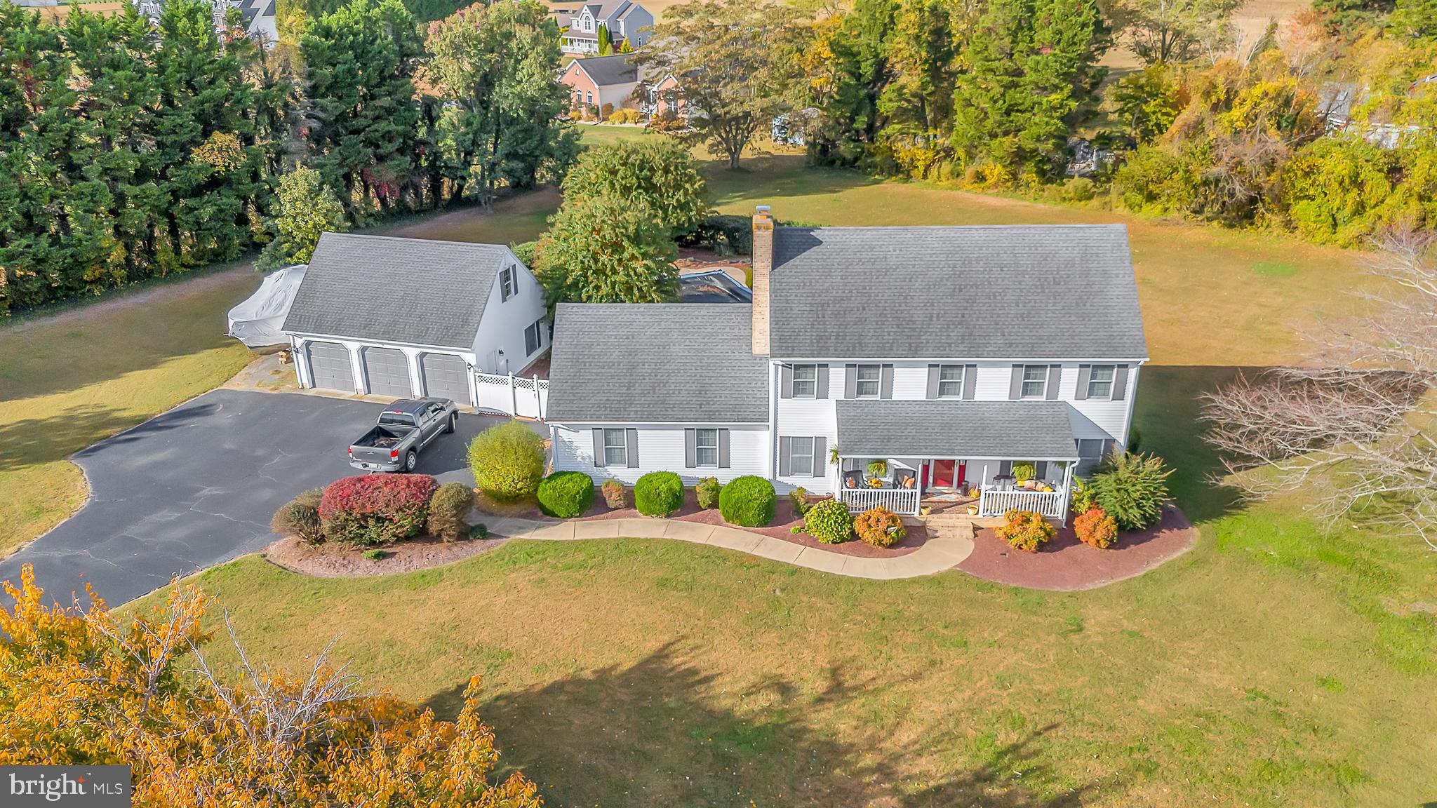 an aerial view of a house with swimming pool and an outdoor seating