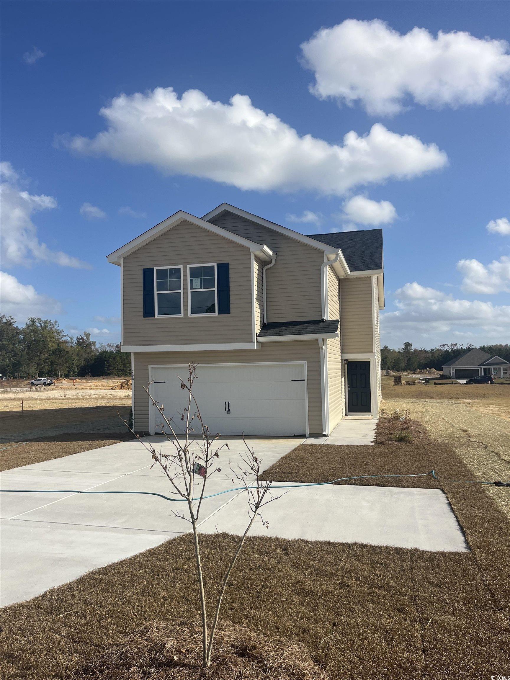 View of front facade featuring a garage