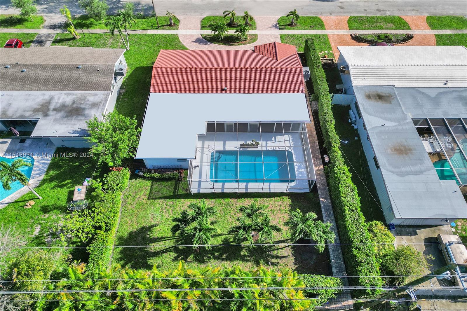 an aerial view of a house with a yard and potted plants