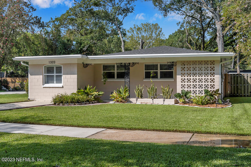 a front view of house with yard and green space