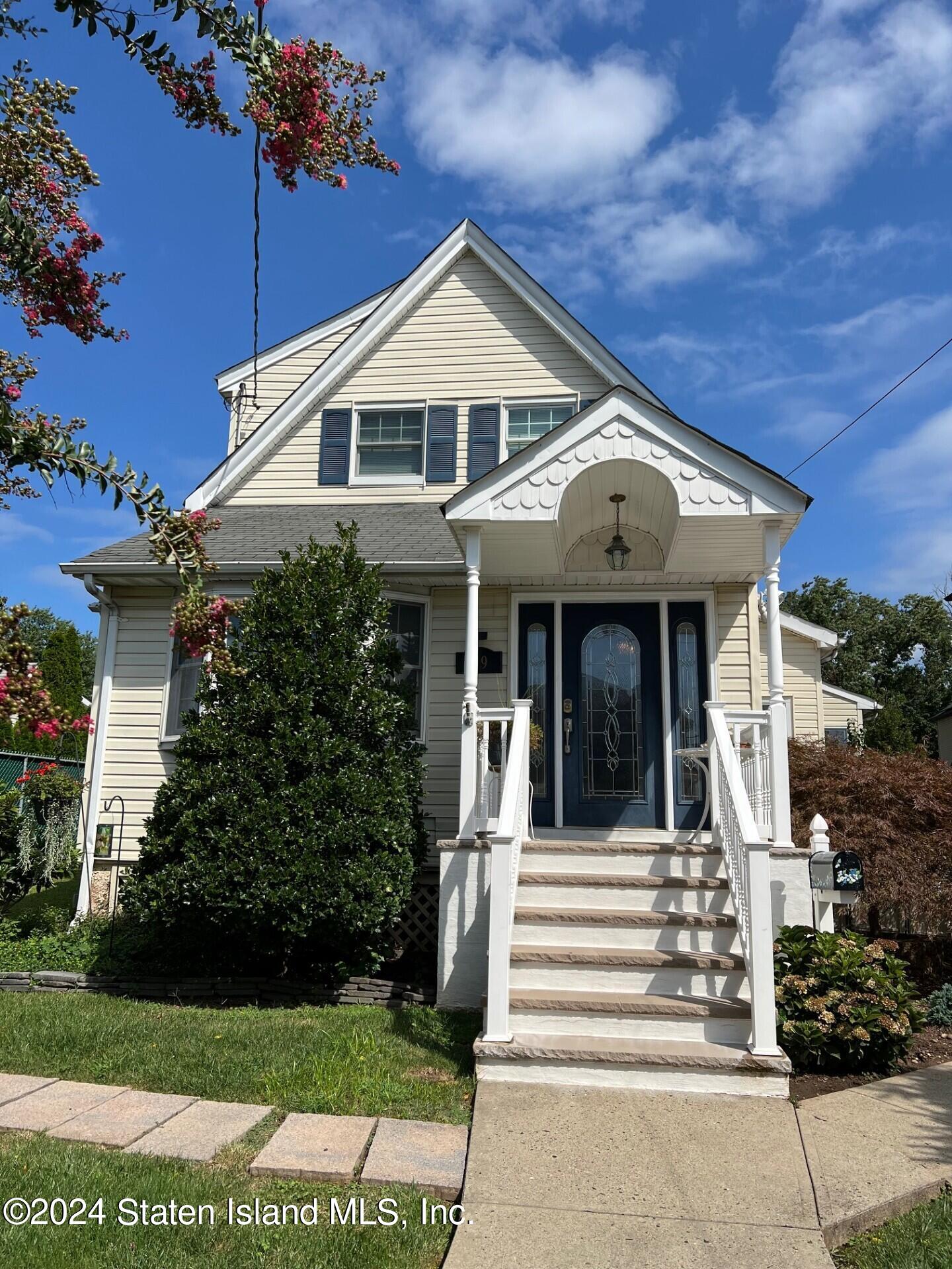 a front view of a house with a garden