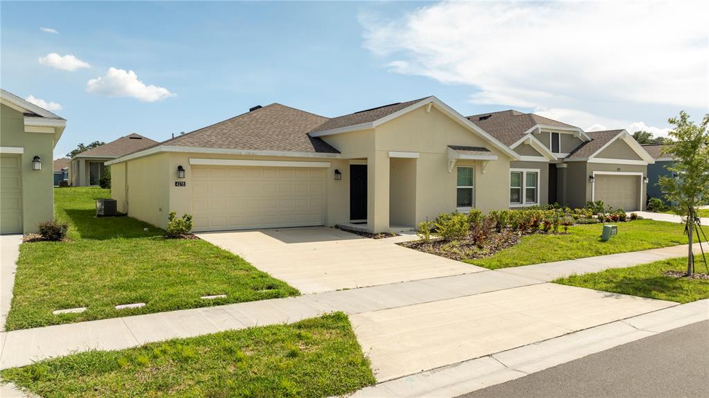 a front view of a house with a yard and garage