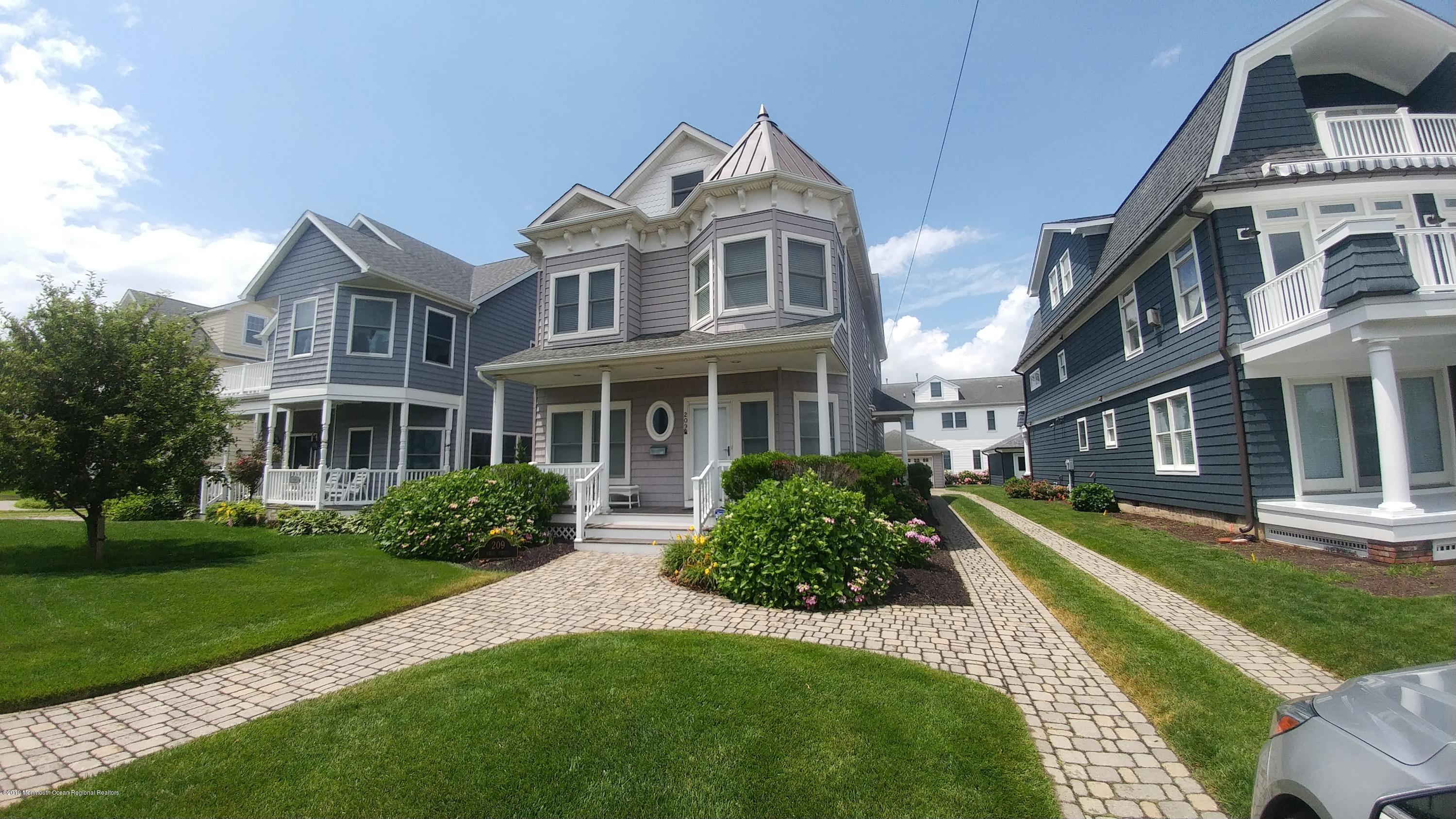 a front view of a residential apartment building with a yard