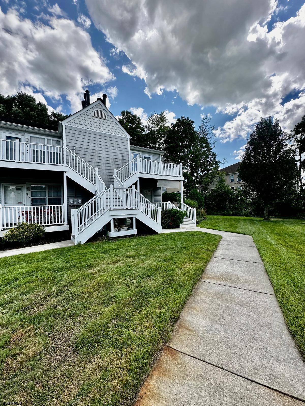 a view of a house with a yard