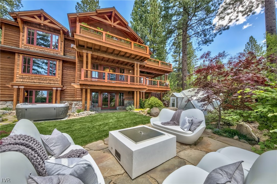 a view of a patio with couches chairs and a fire pit