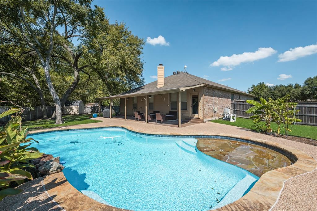 a view of house with swimming pool outdoor seating