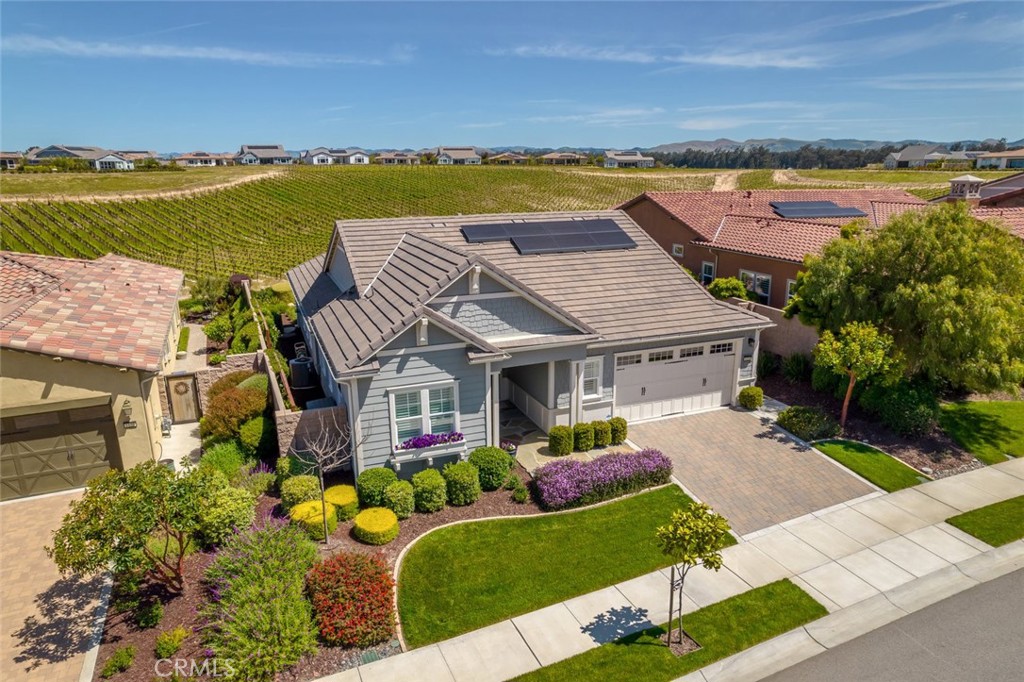 an aerial view of a house with a garden and lake view