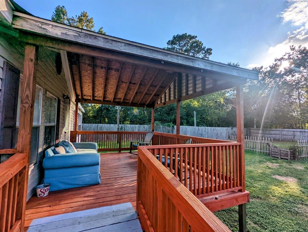 a view of deck with a table and chairs