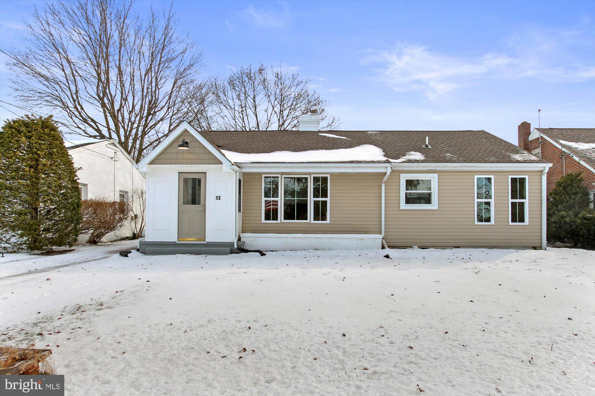 a front view of a house with a covered with snow