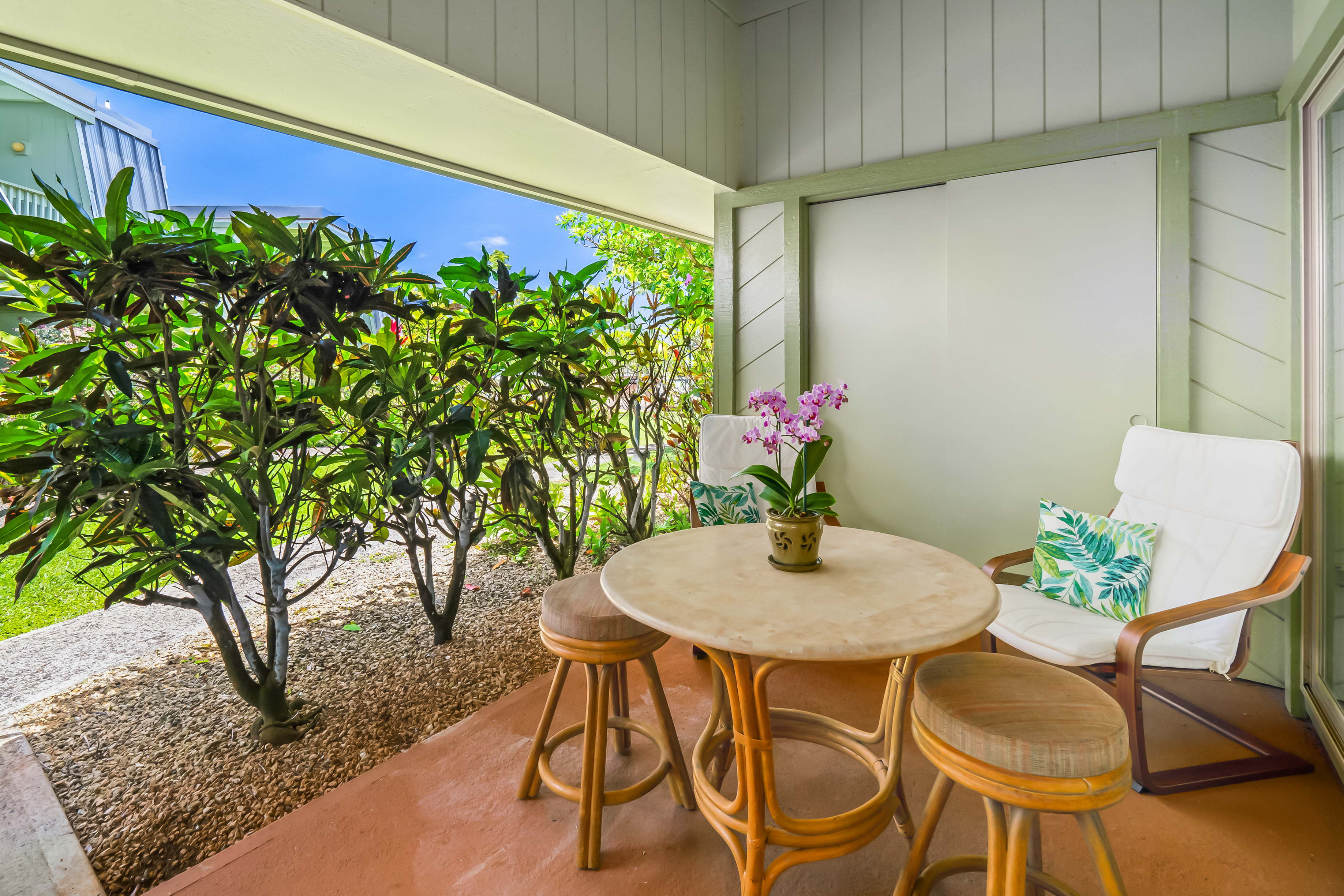 a dining room with furniture and a potted plant