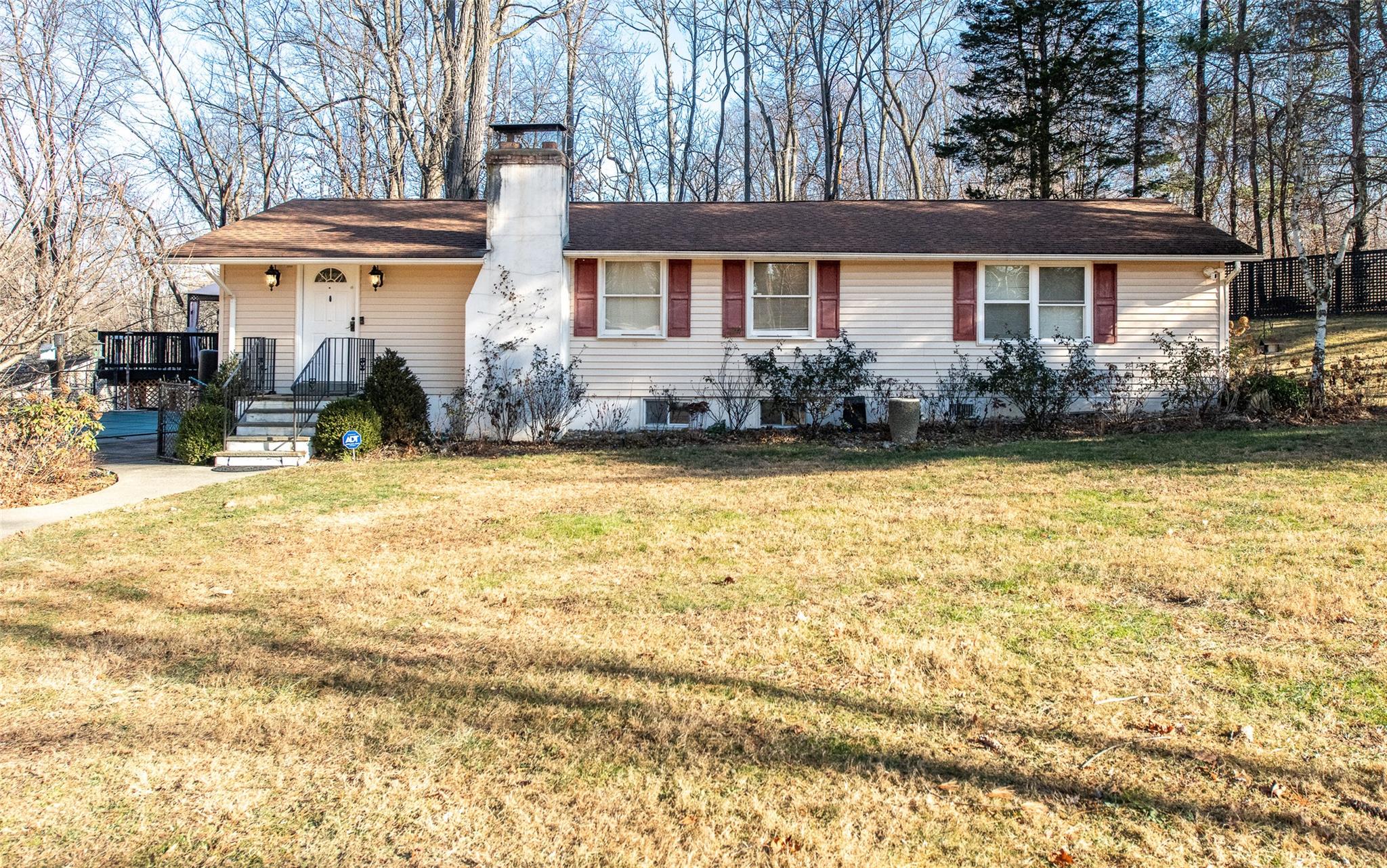 a front view of a house with swimming pool and porch with furniture